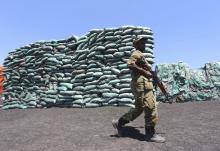 A Somalian soldier walks past a consignment of charcoal destined for the export market in Barawe, October 12, 2014. PHOTO BY REUTERS/Feisal Omar