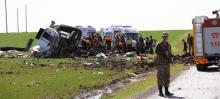 Members of emergency services work next to a damaged military vehicle near Diyarbakir, Turkey, February 18, 2016. PHOTO BY REUTERS/Cihan News Agency