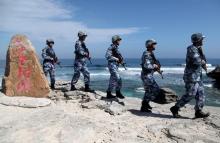 Soldiers of China's People's Liberation Army (PLA) Navy patrol at Woody Island, in the Paracel Archipelago, which is known in China as the Xisha Islands, January 29, 2016. PHOTO BY REUTERS/Stringer