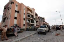 Libyan forces allied with the U.N.-backed government gather in front of ruined buildings at the eastern frontline of fighting with Islamic State militants, in Sirte's neighbourhood 650, Libya, October 21, 2016. PHOTO BY REUTERS/Ismail Zitouny