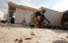 Iraqi soldiers take cover during operation against Islamic State militants in the frontline neighbourhood of Intisar, eastern Mosul, November 27, 2016. PHOTO BY REUTERS/Mohammed Salem