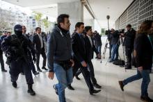 The eight Turkish soldiers, who fled to Greece in a helicopter and requested political asylum after a failed military coup against the government, are escorted by police officers as they arrive at the Supreme Court in Athens, Greece, January 26, 2017. PHOTO BY REUTERS/Alkis Konstantinidis