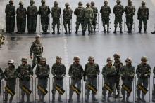 Soldiers take position along roads blocked around the Victory Monument, where anti-coup protesters were gathering on previous days, in Bangkok