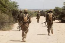 Kenya Defence Forces (KDF) soldiers, who are part of the African Mission in Somalia (AMISOM), secure an area during a foot patrol on the outskirts of the controlled area of the old airport in the coastal town of Kismayu in southern Somalia, November 12, 2013. PHOTO BY REUTERS/Siegfried Modola