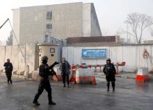 Afghan policemen stand guard outside the government compound after an attack in Kabul, Afghanistan, December 25, 2018. PHOTO BY REUTERS/Mohammad Ismail