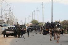 Italian and Somali security forces are seen near armoured vehicles at the scene of an attack on an Italian military convoy in Mogadishu, Somalia, September 30, 2019. PHOTO BY REUTERS/Feisal Omar