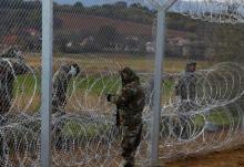 Macedonian soldiers erect a barbed wire fence on the Macedonian-Greek border, near Gevgelija, Macedonia, November 29, 2015. PHOTO BY REUTERS/Ognen Teofilovski