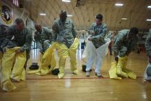 Soldiers wearing protective suits as US Army soldiers from the 101st Airborne Division (Air Assault), who are earmarked for the fight against Ebola, conduct training before their deployment to West Africa, at Fort Campbell, Kentucky, October 9, 2014. PHOTO BY REUTERS/Harrison McClary