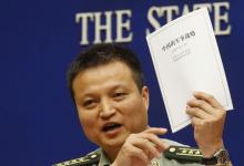 Spokesperson of Chinese Ministry of National Defense Senior Colonel Yang Yujun holds a copy of the annual white paper on China's military strategy during a news conference in Beijing, China, May 26, 2015. PHOTO BY REUTERS/Kim Kyung-Hoon