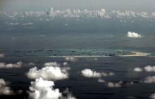 An aerial photo taken though a glass window of a Philippine military plane shows the alleged on-going land reclamation by China on mischief reef in the Spratly Islands in the South China Sea, west of Palawan, Philippines, May 11, 2015. PHOTO BY REUTERS/Ritchie B. Tongo