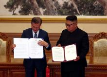 South Korean President Moon Jae-in and North Korean leader Kim Jong Un pose for photographs with the joint statement in Pyongyang, North Korea, September 19, 2018. PHOTO BY REUTERS/Pyeongyang Press Corps