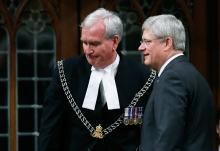 Prime Minister Stephen Harper turns after shaking hands with Sergeant-at-Arms Kevin Vickers in the House of Commons in Ottawa, October 23, 2014. PHOTO BY REUTERS/Chris Wattie