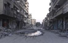 A general view shows a deserted street filled with debris of damaged buildings in Deir al-Zor, March 5, 2014. PHOTO BY REUTERS/Stringer