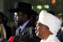 Sudanese President Omar al-Bashir (R) listens as his South Sudanese counterpart Salva Kiir speaks during a joint news conference