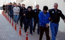 Suspected supporters of the U.S.-based cleric Fethullah Gulen are escorted by plainclothes police officers as they arrive at the police headquarters in Kayseri, Turkey, April 25, 2017. PHOTO BY Olcay Duzgun/Dogan News Agency