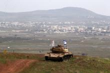 An old military vehicle can be seen positioned on the Israeli side of the border with Syria, near the Druze village of Majdal Shams in the Israeli-occupied Golan Heights, Israel, February 11, 2018. PHOTO BY REUTERS/Ammar Awad