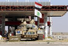 A tank belonging to the Shi'ite Badr Brigade militia takes position in front of a gas station in Suleiman Beg, northern Iraq, September 9, 2014. PHOTO BY REUTERS/Ahmed Jadallah