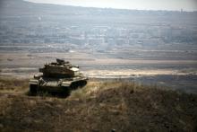 The Syrian area of Quneitra is seen in the background as an out-of-commission Israeli tank parks on a hill, near the ceasefire line between Israel and Syria, in the Israeli-occupied Golan Heights, August 21, 2015. PHOTO BY REUTERS/Baz Ratner