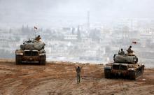 Turkish army tanks take position on top of a hill near Mursitpinar border crossing in the southeastern Turkish town of Suruc in Sanliurfa province, Turkey, October 11, 2014. PHOTO BY REUTERS/Umit Bektas
