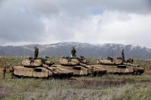 Israeli soldiers stand atop tanks in the Golan Heights near Israel's border with Syria, March 19, 2014. PHOTO BY REUTERS/Ronen Zvulun