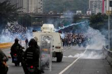 Police fire tear gas toward opposition supporters during clashes while rallying against Venezuela's President Nicolas Maduro in Caracas, Venezuela. PHOTO BY REUTERS/Carlos Garcia Rawlins