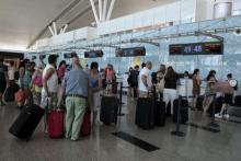 Tourists wait to check in for their flight to Manchester, Britain, at the Enfidha international airport, Tunisia, June 27, 2015. PHOTO BY REUTERS/Zoubeir Souissi