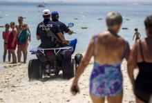 Police officers patrol the beach near the Imperial Marhabada resort, which was attacked by a gunman in Sousse, Tunisia, June 28, 2015. PHOTO BY REUTERS/Zohra Bensemra