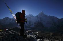 A trekker stands in front of Mount Everest, which is 8,850 meters high (C), at Kala Patthar in Solukhumbu District, May 7, 2014. PHOTO BY REUTERS/Navesh Chitrakar
