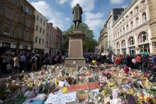 Messages and floral tributes left for the victims of the attack on Manchester Arena lie around the statue in St Ann's Square in central Manchester, May 24, 2017. PHOTO BY REUTERS/Jon Super