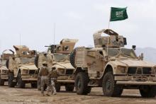 Saudi troops walk past armoured personnel carriers at their base in Yemen's southern port city of Aden, September 28, 2015. PHOTO BY REUTERS/Faisal Al Nasser
