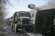 Trucks of the separatist self-proclaimed Donetsk People's Republic army towing mobile artillery cannons, are seen as they pull back from Donetsk, February 24, 2015. PHOTO BY REUTERS/Baz Ratner