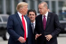 U.S. President Donald Trump and Turkish President Tayyip Erdogan gesture as they talk at the start of the NATO summit in Brussels, Belgium, July 11, 2018. PHOTO BY REUTERS/Kevin Lamarque