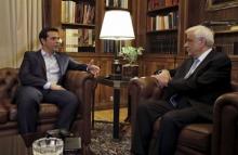 Greek Prime Minister Alexis Tspiras (L) is received by Greece's President Prokopis Pavlopoulios in Athens, Greece, August 20, 2015. PHOTO BY REUTERS/Alkis Konstantinidis