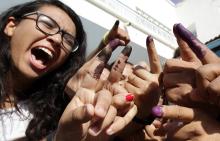 Tunisians show their ink-stained fingers after casting their votes, in Tunis October 26, 2014. Tunisians voted on Sunday in parliamentary elections that bring full democracy finally within their reach, four years after their revolution cast out autocrat Zine El-Abidine Ben Ali. PHOTO BY REUTERS/Anis Mili