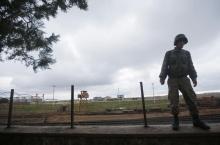 A Turkish soldier takes up position near the border with Syria, in the Turkish border town of Ceylanpinar, Sanliurfa province