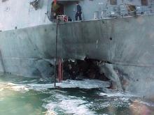 The port side damage to the guided missile destroyer USS Cole is pictured after a bomb attack during a refueling operation in the port of Aden in this October 12, 2000. PHOTO BY REUTERS/Aladin Abdel Naby