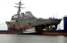 The guided missile destroyer USS Cole arrives at Ingalls east bank facility in Pascagoula, Mississippi, December 13, 2000 aboard the Norwegian commercial lift ship MV Blue Marlin. PHOTO BY REUTERS/HO/Leland Comer