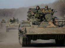 Members of the Ukrainian armed forces ride military vehicles near Artemivsk, eastern Ukraine, February 22, 2015. PHOTO BY REUTERS/Gleb Garanich