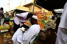 A vendor writes in a notebook at a market in Khartoum, July 28, 2016. PHOTO BY REUTERS/Mohamed Nureldin Abdallah