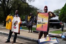 Local craftsmen offer T shirts, pictures and clothing for sale to tourists arriving by bus at a hotel in Kumasi, Ashanti Region, Ghana, August 10, 2019. PHOTO BY REUTERS/Francis Kokoroko