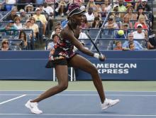 Venus Williams of the U.S. hits a return to Zheng Jie of China