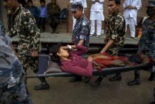 Nepal military personnel carry an earthquake victim on a stretcher as she arrives at the Gorkha hospital in Gorkha, Nepal, April 28, 2015. PHOTO BY REUTERS/Athit Perawongmetha