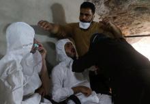 A man breathes through an oxygen mask as another one receives treatments, after what rescue workers described as a suspected gas attack in the town of Khan Sheikhoun in rebel-held Idlib, Syria April 4, 2017. PHOTO BY REUTERS/Ammar Abdullah