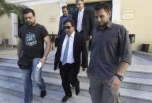 Greek shipowner Victor Restis (C) leaves a court in Athens