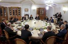Russian President Vladimir Putin (4th, background) chairs a meeting with foreign news agency chiefs at the Boris Yeltsin presidential library in St. Petersburg, Russia, June 19, 2015. PHOTO BY REUTERS/Grigory Dukor