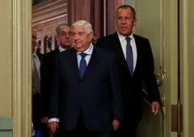 Syrian Foreign Minister Walid al-Moualem and Russian Foreign Minister Sergei Lavrov enter a hall for a joint news conference following their talks in Moscow, Russia, August 30, 2018. PHOTO BY REUTERS/Maxim Shemetov