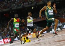 Wayde van Niekerk of South Africa (R) runs past Kirani James of Grenada (L) and Isaac Makwala of Botswana to win the men's 400 metres final at the IAAF World Championships at the National Stadium in Beijing, China, August 26, 2015. PHOTO BY REUTERS/Damir Sagolj