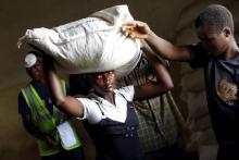 A woman carries food aid distributed by the United Nations World Food Progamme (WFP) in Mzumazi village near Malawi's capital Lilongwe, February 3, 2016. PHOTO BY REUTERS/Mike Hutchings