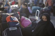 A Palestinian woman looks on as she waits for a travel permit to cross into Egypt, at the Rafah border crossing between Egypt and the southern Gaza Strip, June 13, 2015. PHOTO BY REUTERS/Mohammed Salem