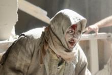 An injured woman reacts at a site hit by airstrikes in the rebel held area of Old Aleppo, Syria, April 28, 2016. PHOTO BY REUTERS/Abdalrhman Ismail